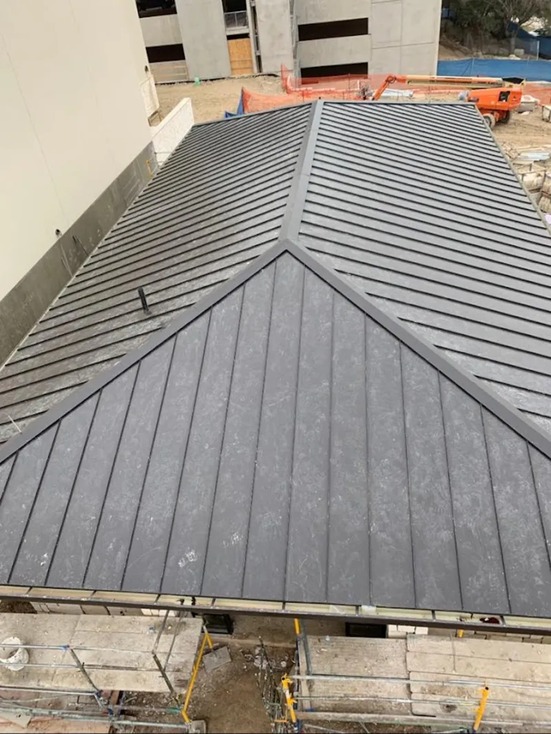 Commercial metal roof construction with crane equipment in Contra Costa Centre